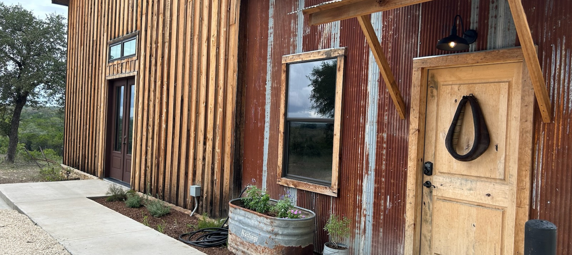 Image of exterior entrance of the barn room at Inn at Sunset Mill Ranch