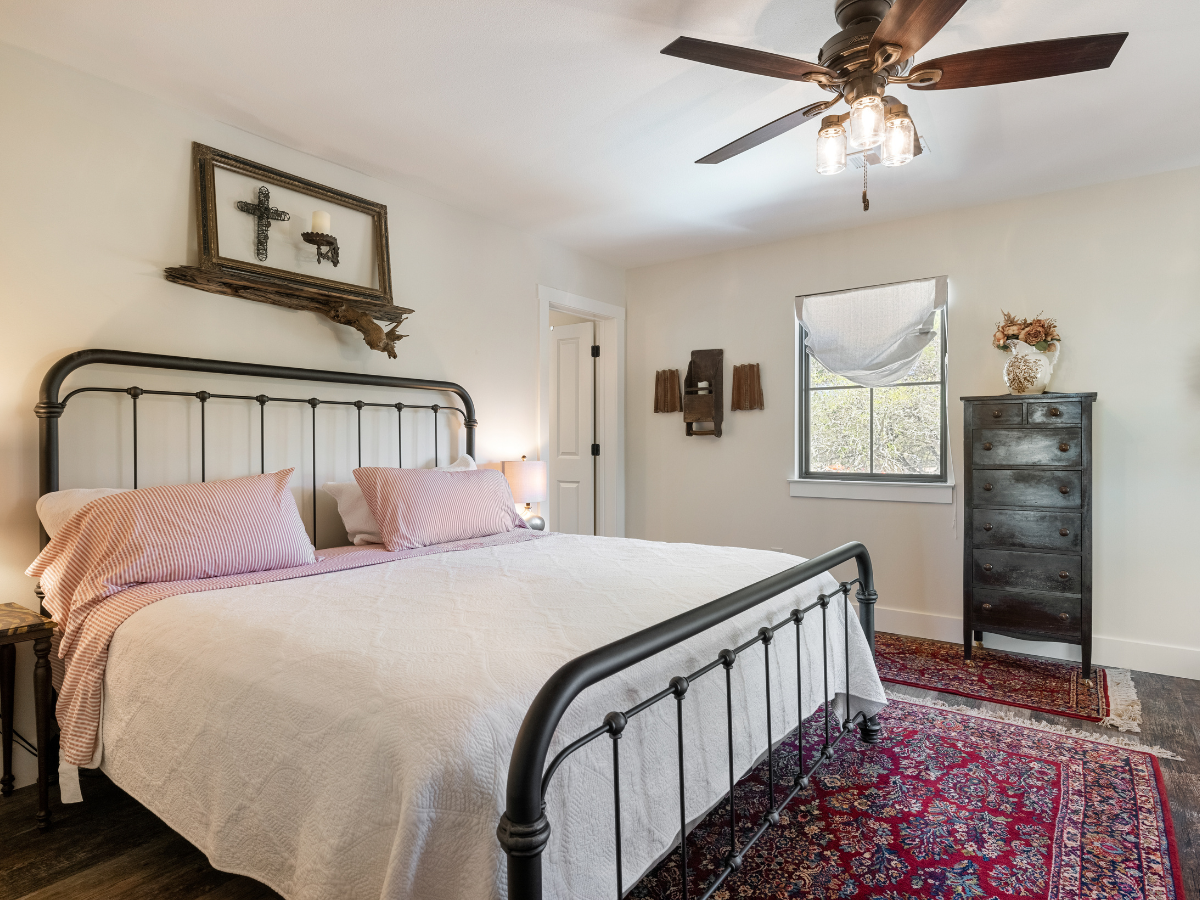 Image of king room with white bedspread at Texas Hill Country Hotel