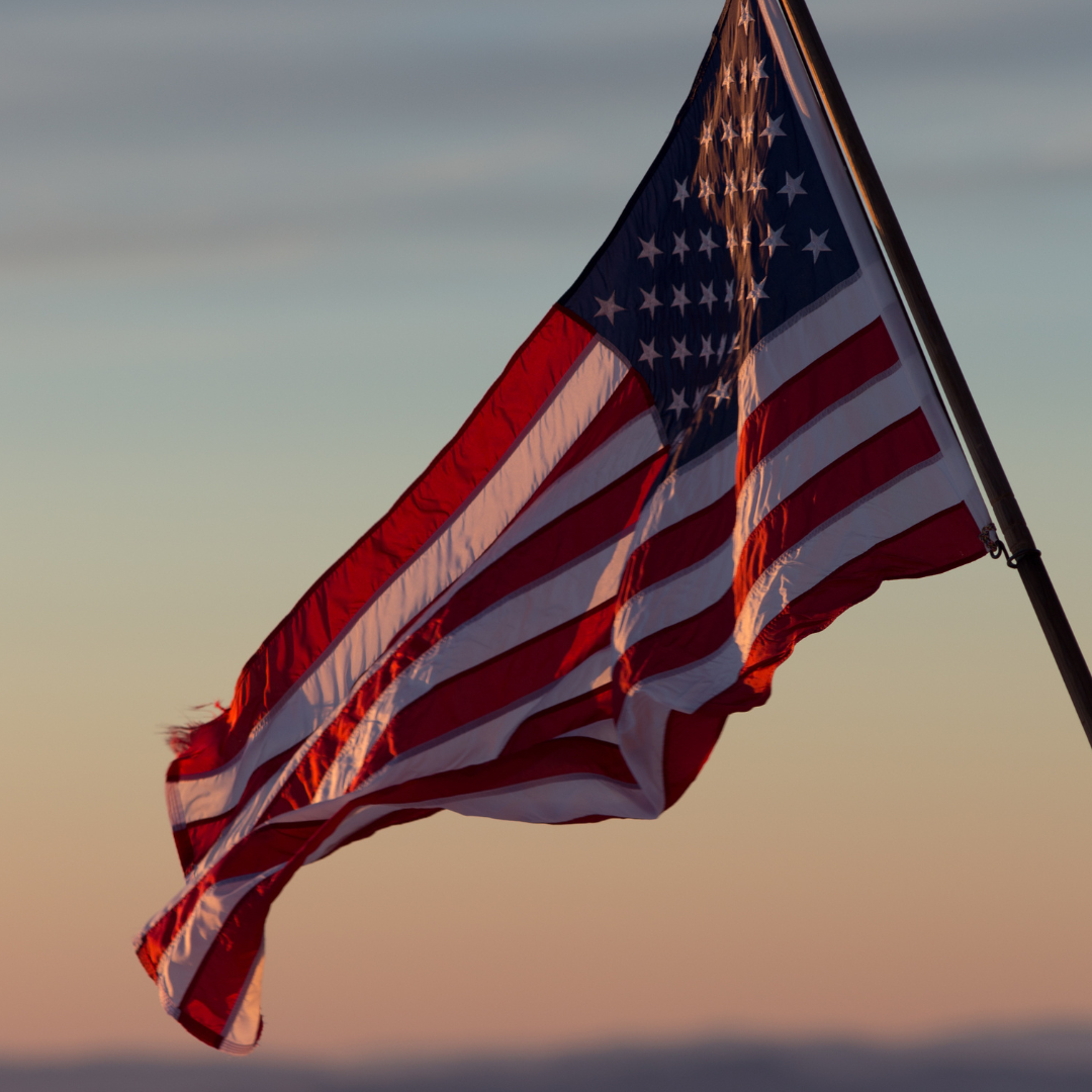 Image of American Flag in sunset sky
