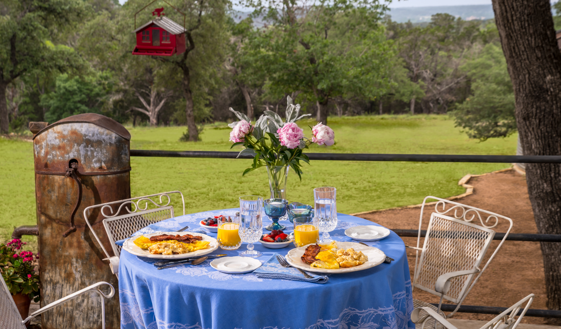 Image of breakfast patio table overlooking texas hill country views at Inn at Sunset Mill Ranch bed and breakfast