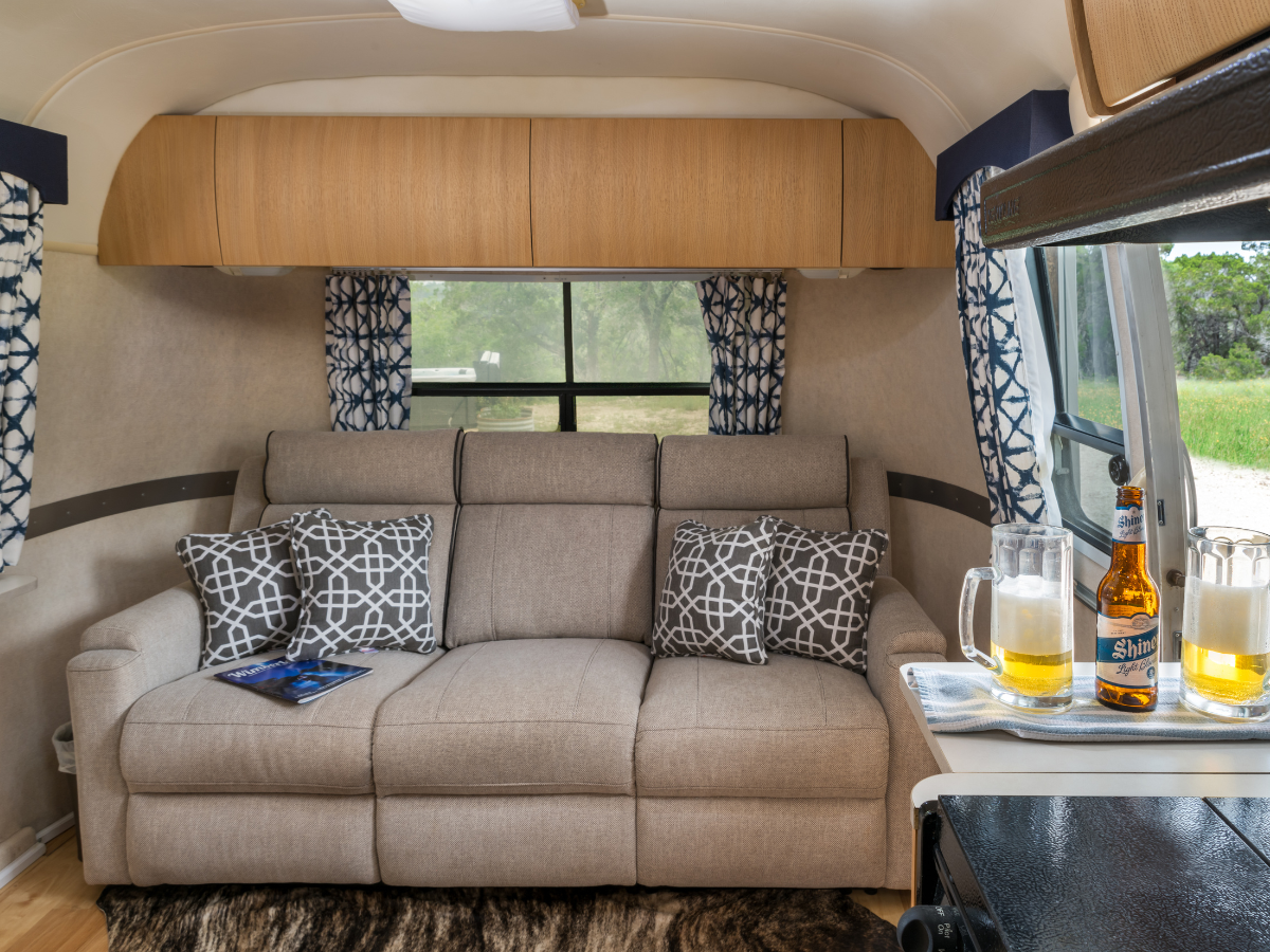 Image of sofa and two beer mugs in Airstream Glamper in Texas Hill Country