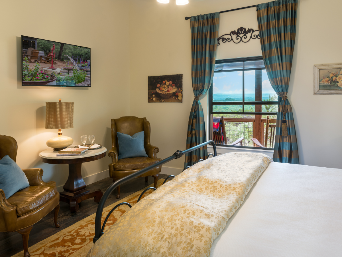 Image of bed with picture window in background at Texas Hill Country hotel