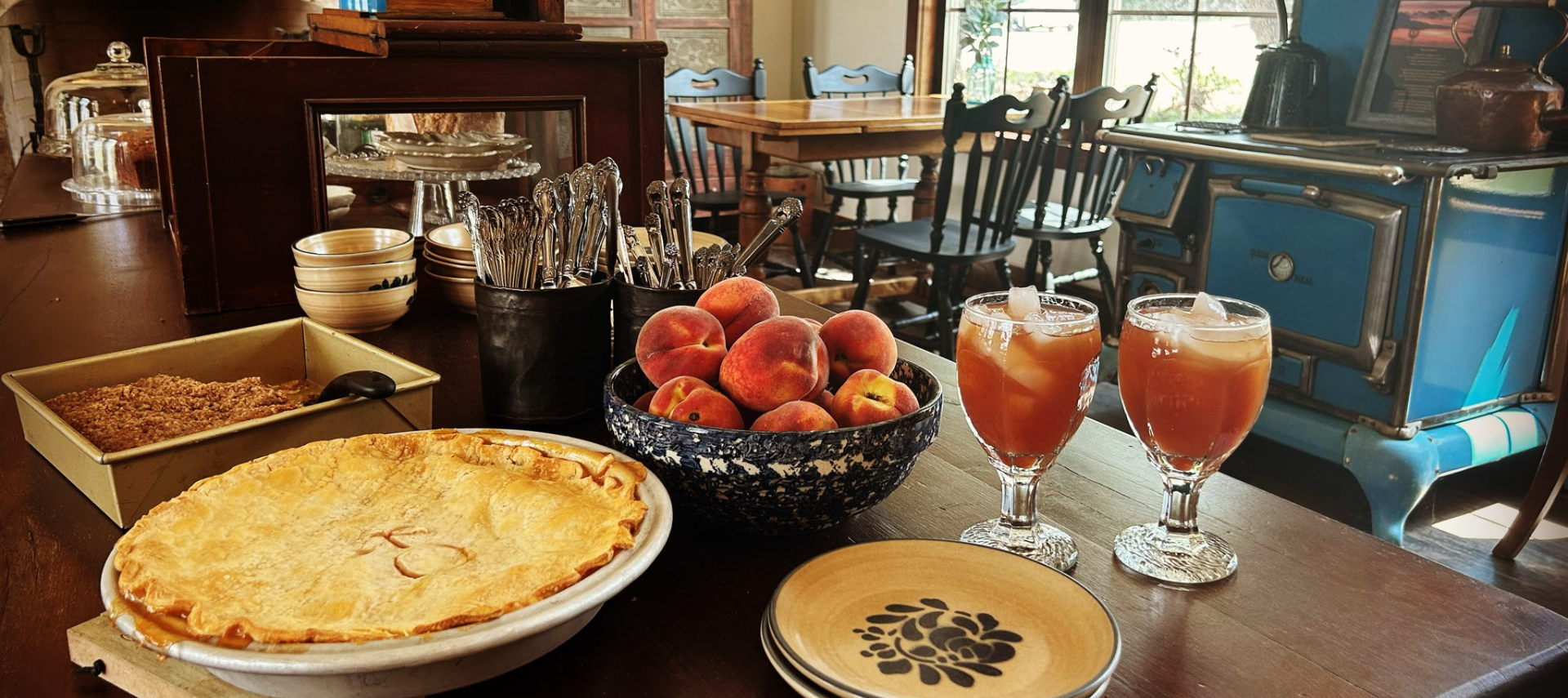 Image of peach pie, peach tea, and fresh peaches