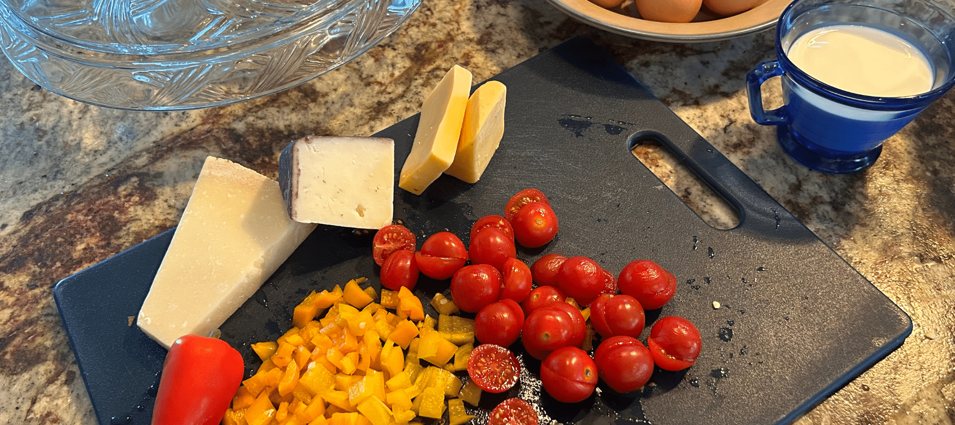 Image of fresh tomato, pepper, and cheese on cutting board showcasing Wimberley restaurants food prep