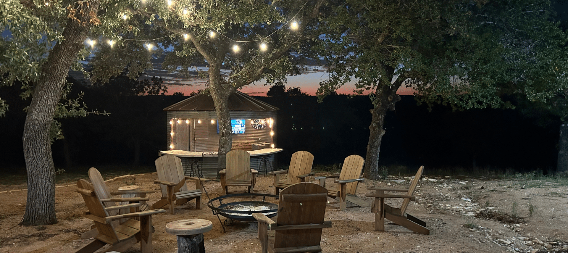 Image of Outdoor Firepit and string lights at night at Inn at Sunset Mill Ranch in Wimberley Texas